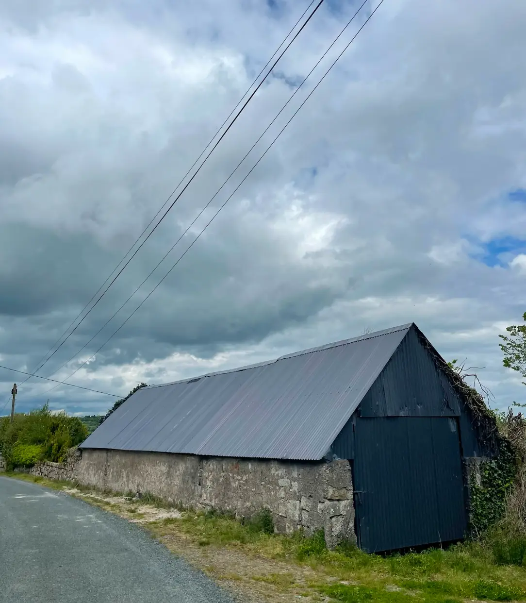 Finished protective coating on a curved corrugated shed roof
